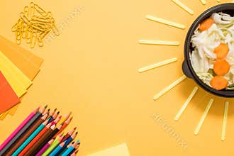 Healthy school lunch for child or teenager. Craft paper package, pile of exercise books, water, bag and food in lunch box on white