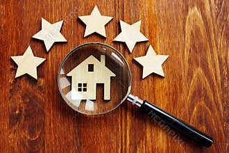 Home appraisal. House with magnifying glass and five star