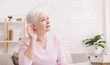 Elderly woman with hearing loss at home