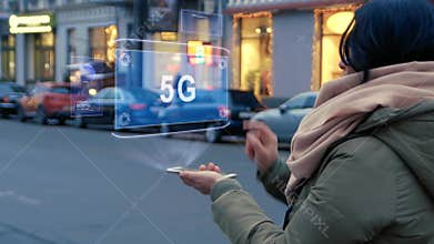 Unrecognizable woman standing on the street interacts HUD hologram with text 5G
