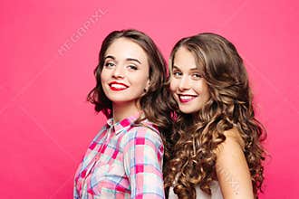 Studio view of beautiful girls with magnificent wavy hair and red lips, in a hipster style with a happy, cute