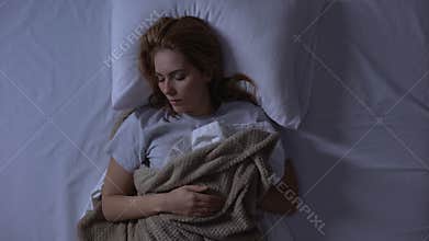 Beautiful woman sleeping soundly in her comfortable orthopedic bed, healthcare