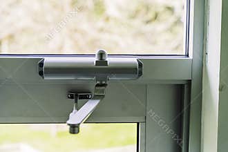 Door Closer on Glass door on building entrace