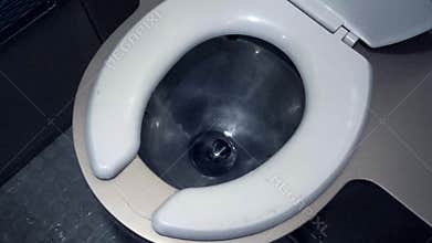 Toilet bowl with running water.