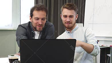 Two businessmen working together at the office