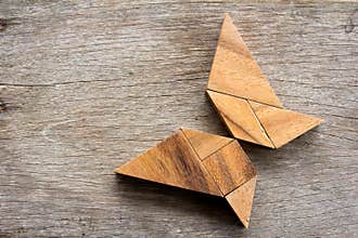 Wooden tangram puzzle in flying butterfly shape