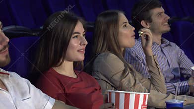 Two couples spend a double date at the cinema and watch the movie