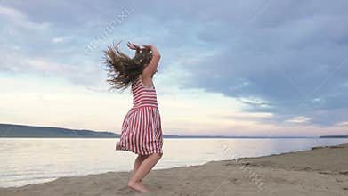 Happy one child on beach jump dancing.