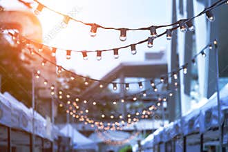 Party string lights hanging in a line on street in Bangkok, Thai