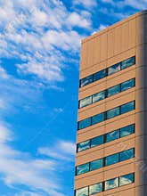Skyscraper With Geometric Designed Windows In The Blue Sky