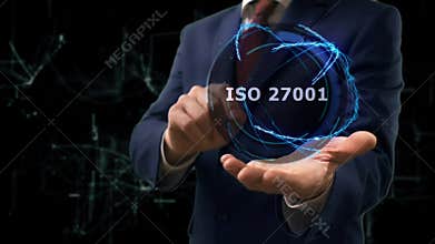 Businessman shows concept hologram ISO 27001 on his hand