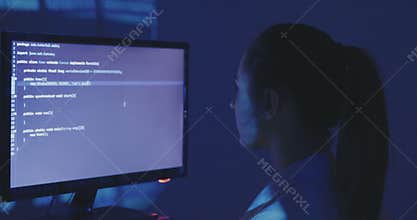 Experienced IT woman programmer works on a new program. Young woman hacker writes the source code of the software at