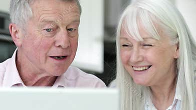 Senior Couple Using Laptop To Connect With Family