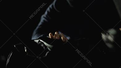 Criminal in black mask stealing drug packages from automobile trunk, robbery