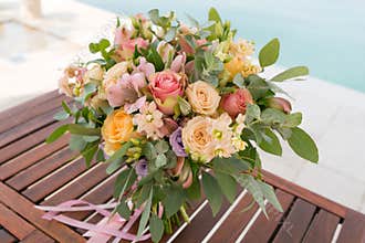 Pink and peach wedding bouquet is on the table