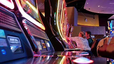 Motion of people playing slot machine inside Casino