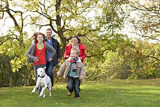 Family Outdoors Walking Through Park