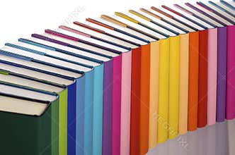 Close-up of rainbow-colored book arrangement