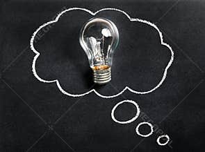 Light bulb on chalkboard. Thinking of new great idea. Brainstorming and creating. Creativity, innovation, inspiration.