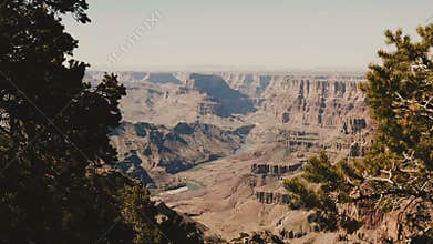Beautiful panoramic shot of epic sunny mountains at amazing Grand Canyon park observation view point with pine trees.