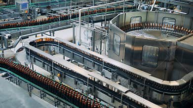Factory conveyors moving beer bottles, top view.