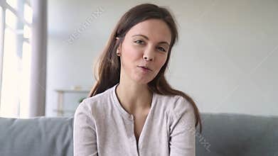 Happy girl talking video calling friend laughing looking at webcam