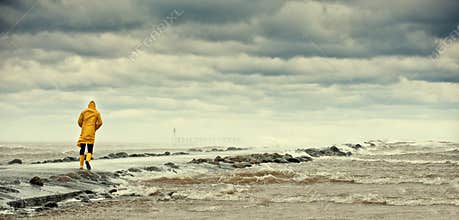 Person walking by stormy sea