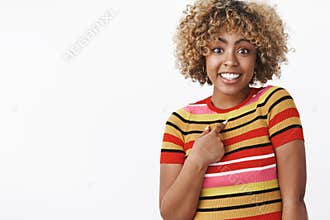 Who me. Portrait of surprised cute and carefree charming african-american girl pointing questioned and excited at