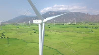 Wind power turbines aerial landscape. Windmill turbine generating clean renewable energy in green agricultural field