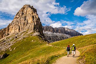 Active senior caucasian couple hiking in mountains with backpacks, enjoying their adventure. Location: Dolomites Alps, South Tyrol