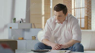 Businessman in trouble counting money. Mortgage loan, bankruptcy