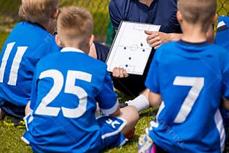 Coaching Kids Soccer. Football Team with Coach at the Stadium. B