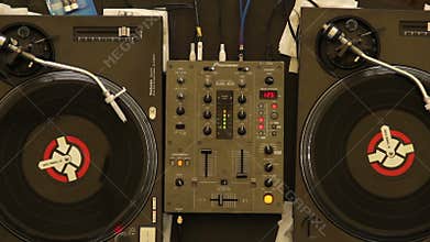 Two spinning turntables platters, nightclub DJ equipment working