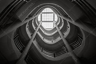 Spiral staircase climbing upward, black and white