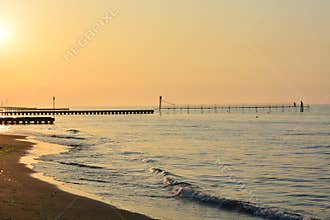 A beautiful sunset on the piers that go towards the open sea