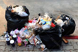 Pile of Garbage plastic black and trash bag waste many on the footpath, pollution trash, Plastic Waste and Bag Foam tray Garbage