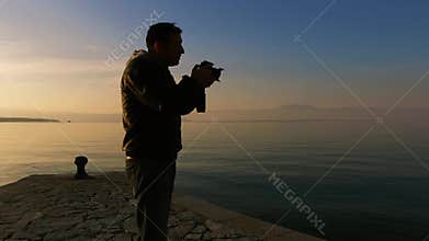 Landscape photographer taking a pictures of sunset