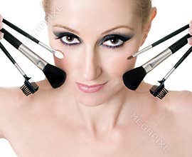 Female face with cosmetic makeup brushes