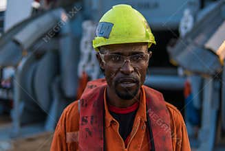 Seaman AB or Bosun on deck of vessel or ship , wearing PPE