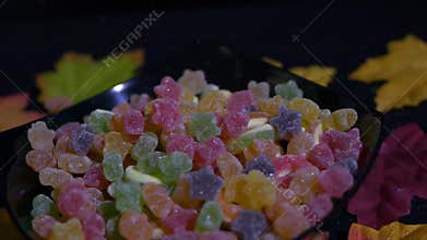 Halloween candy falling in slow motion with maple