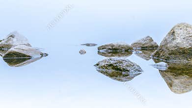 White misty day rocks reflection
