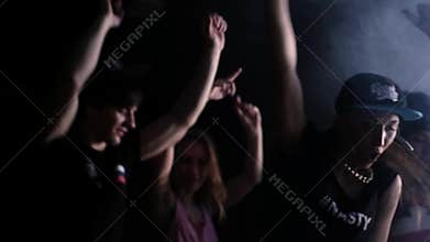 Hip hop party cheerful young men and hot girls dancing in dark room