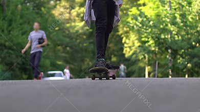 Teenager riding skateboard, adolescent hobby as rebellion and stress reliever