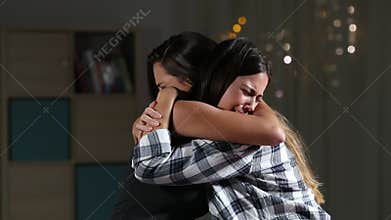 Girl comforting her sad friend at home