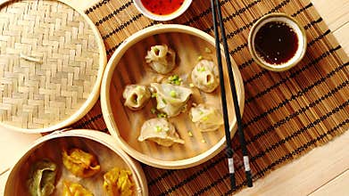 Oriental traditional chinese dumplings served in the wooden steamer