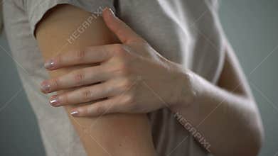 Woman hiding bruises on her arm, problems in family, domestic violence victim