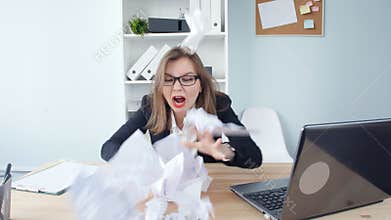 Stress at work concept. Young Business angry woman in the office shouts into the phone