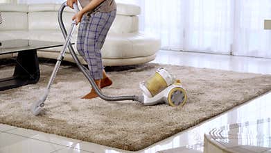 Woman dancing and vacuuming carpet