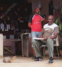 Two Men At Entrance To Small Shop In Cuba