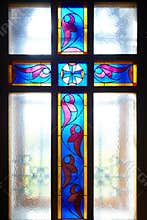 Catholic cross on the window (stained glass)